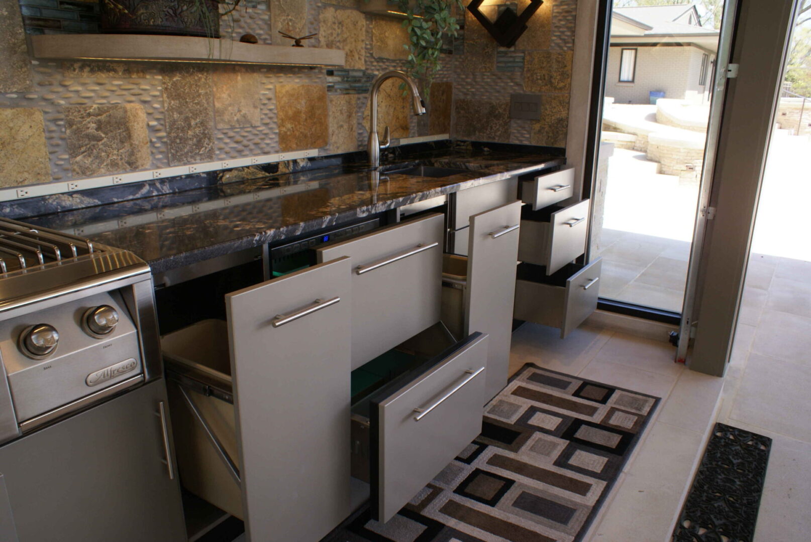 A kitchen with a sink and dishwasher in it