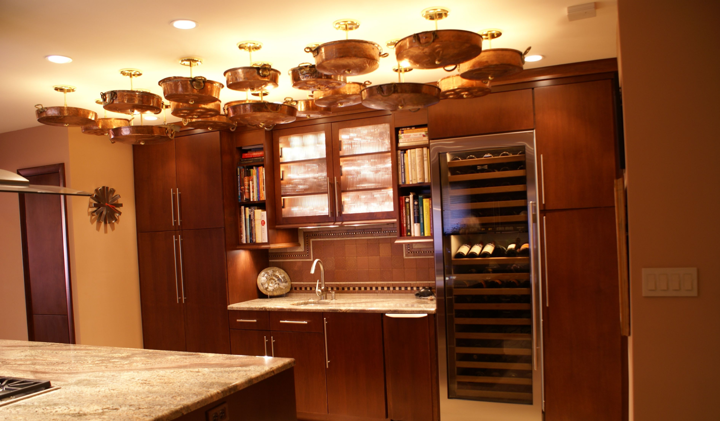A kitchen with wooden cabinets and wine cooler.